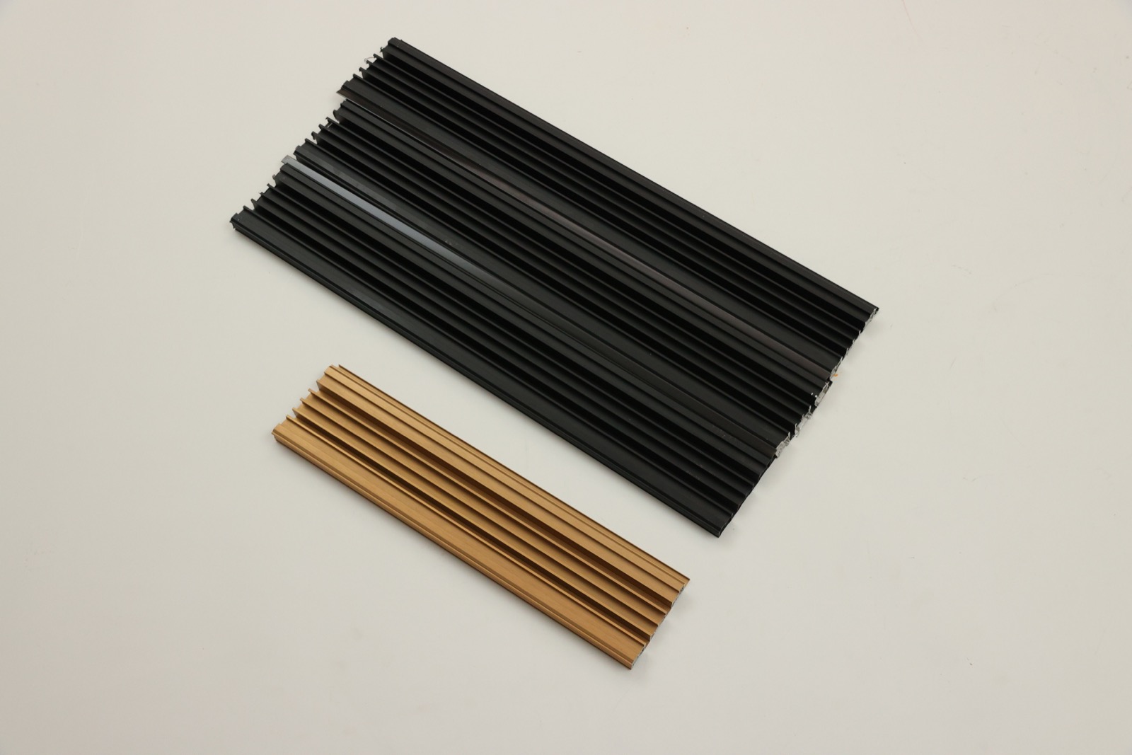 Real black and bronze aluminium QRD profile samples showing their sectional form